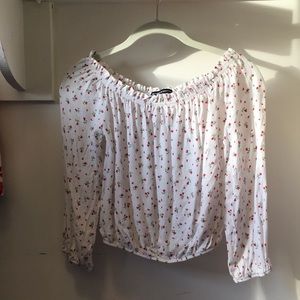 White rose design off the shoulder shirt.